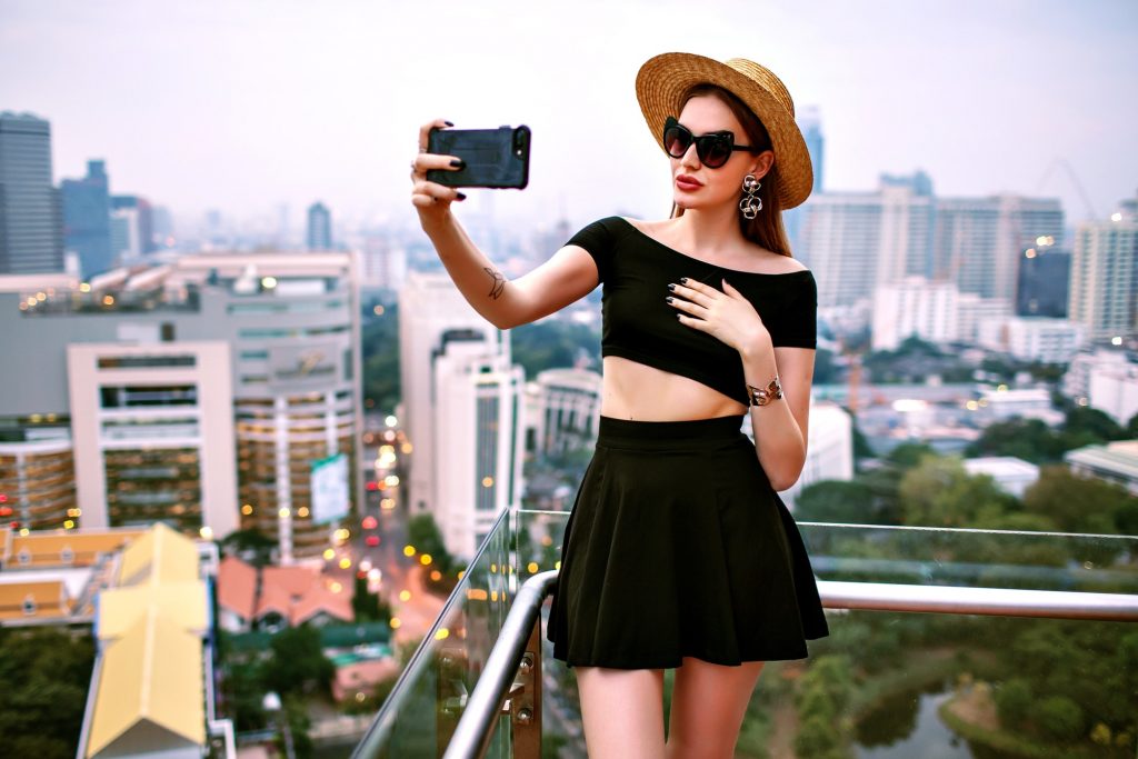 Outdoor travel image posing back at roof top at luxury hotel in Bangkok